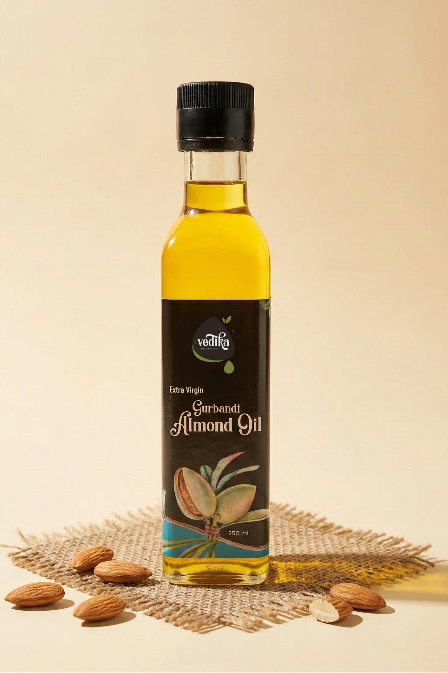 Bottle of almond oil with almonds on a textured surface
